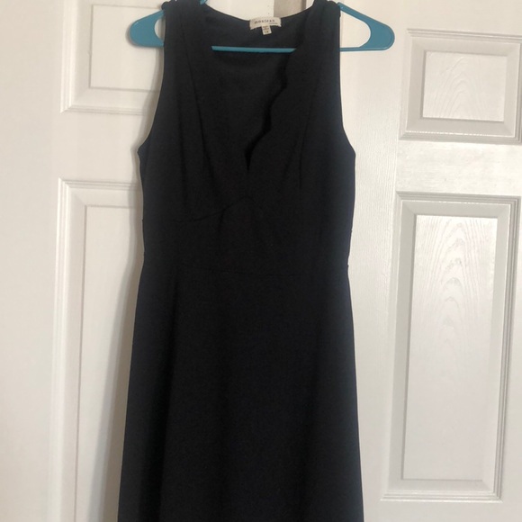 black dress with scalloped neckline